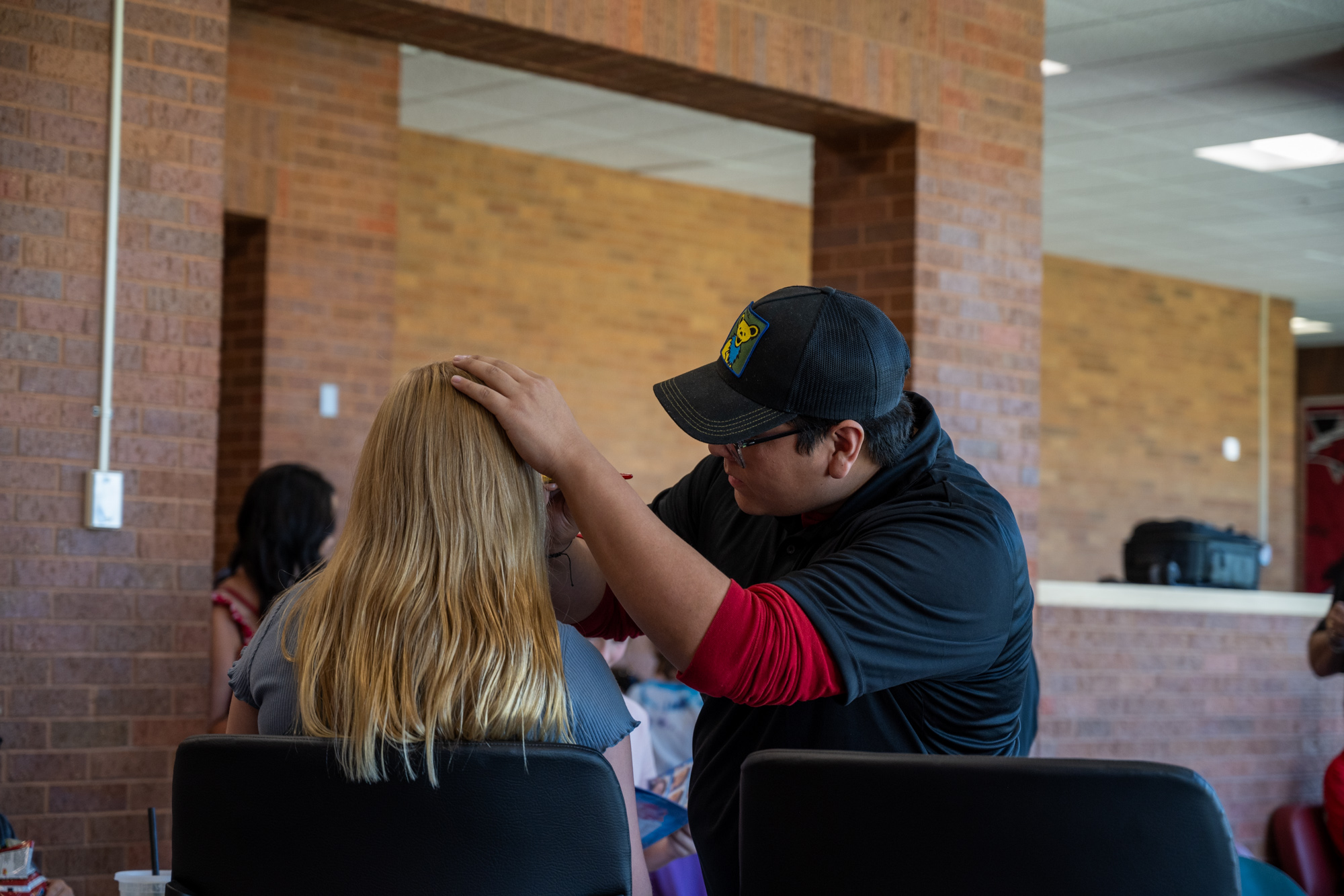 Student painting the face of a young girl