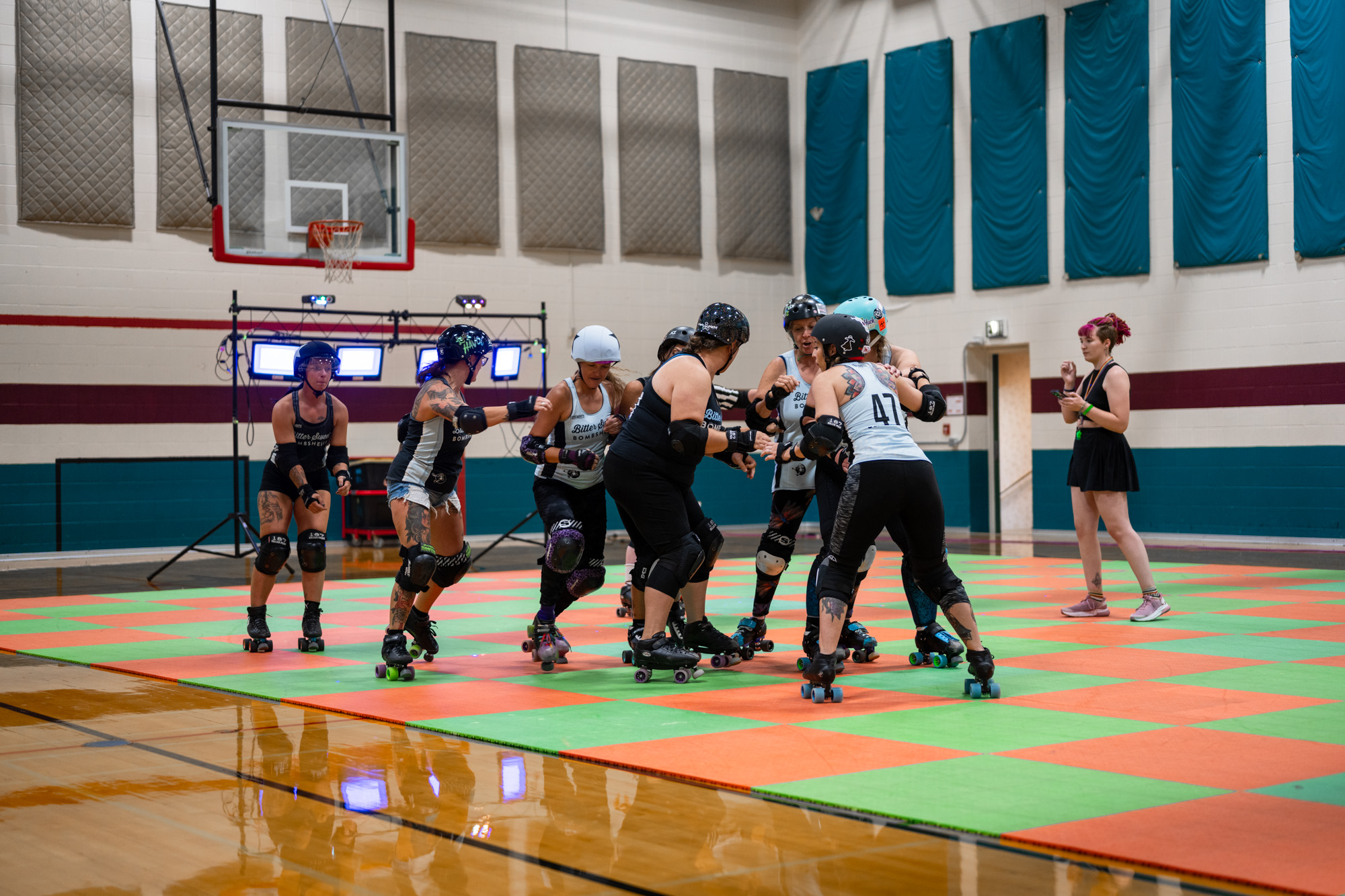 The Bittersweet Bombshells skating group skating in gym