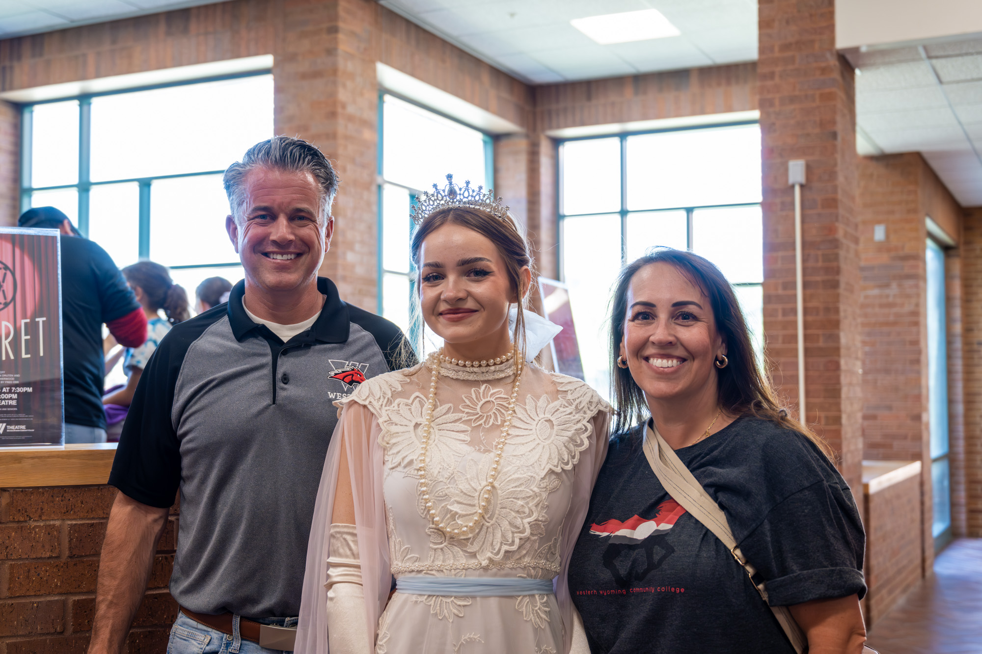 Dr. Young and his wife posing with a student dressed as a princess