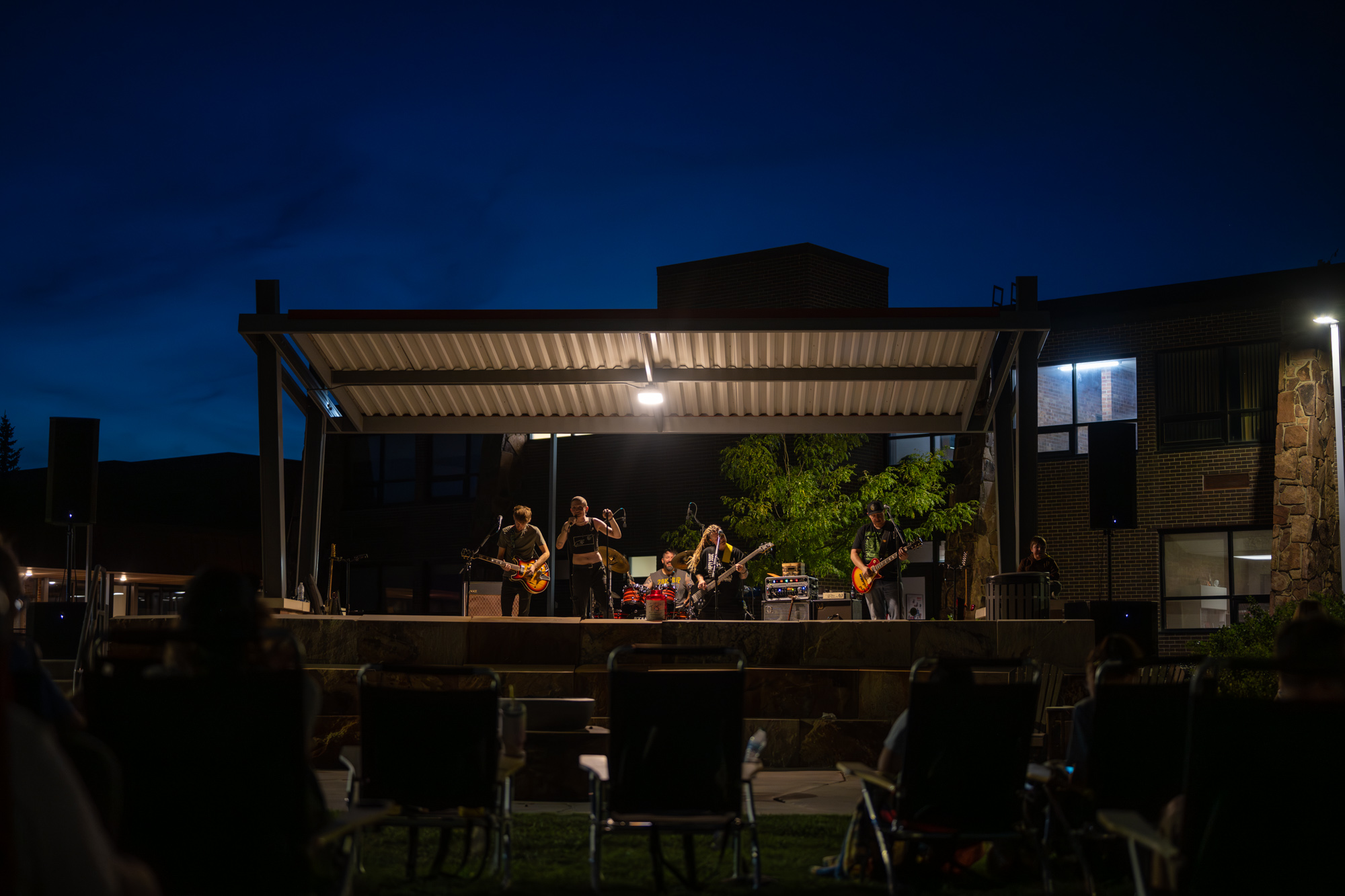 The band Atlas Falls performing from stage at twilight 