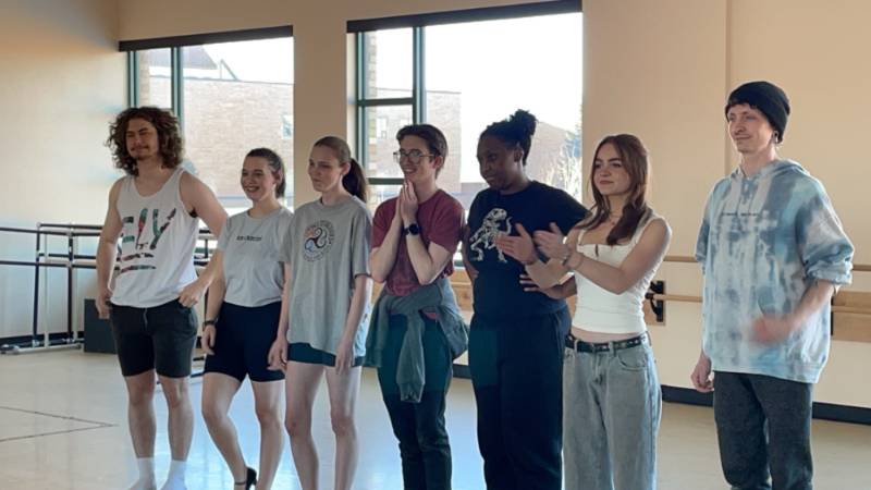 Cabaret cast practicing a line dance. 