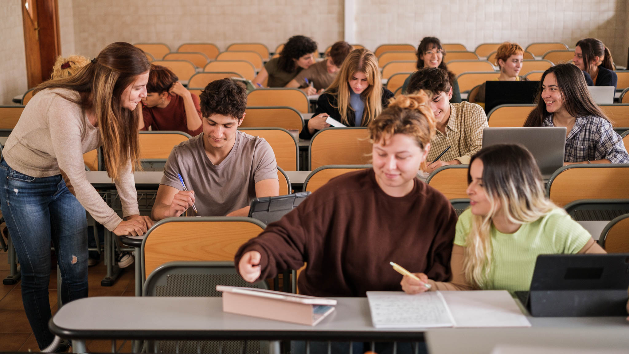 mix of both male and female students sitting in a class room and working