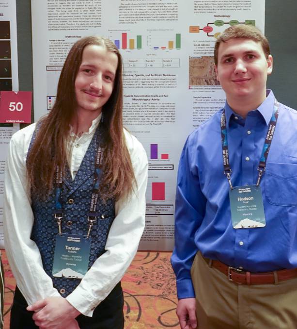 Tanner Robers and Hudson Poyer smile in front of their project.