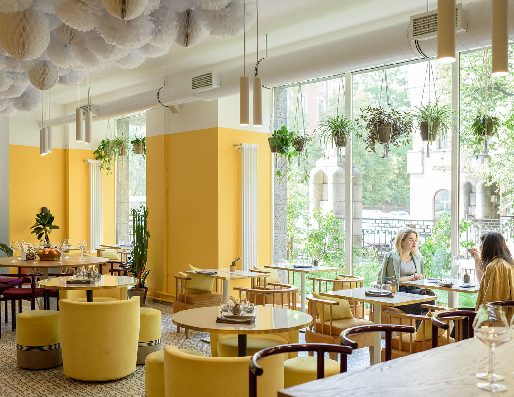 Photo of Diner with chairs and tables with two people eating and talking