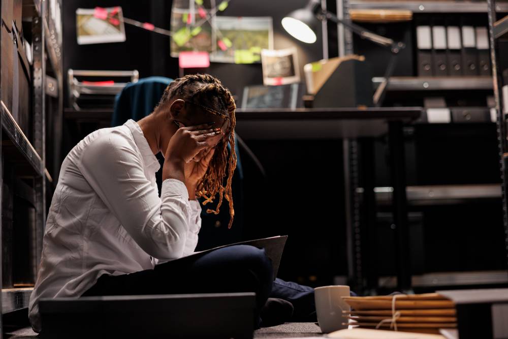 Tired police detective having headache while working late