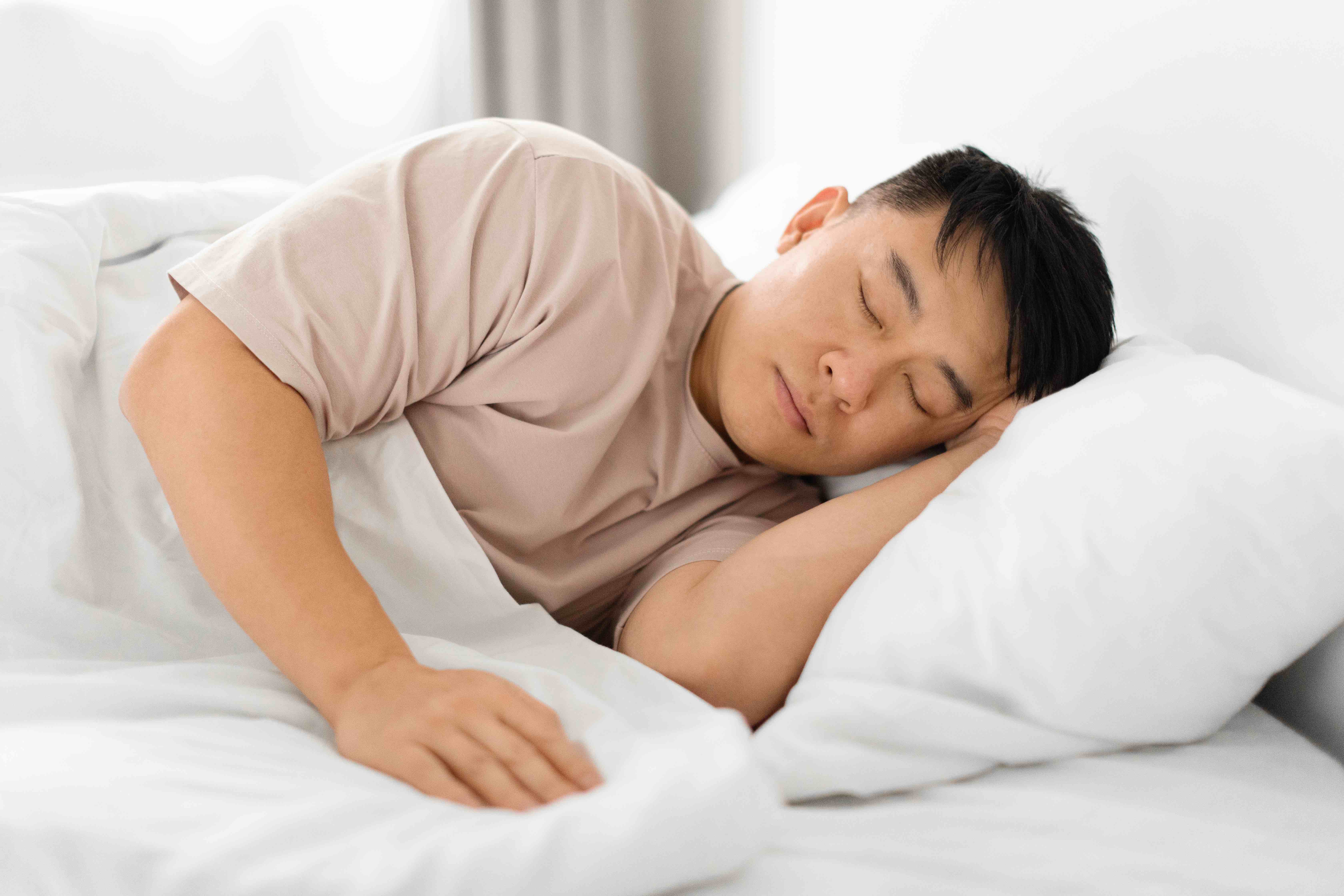 man sleeping in bed