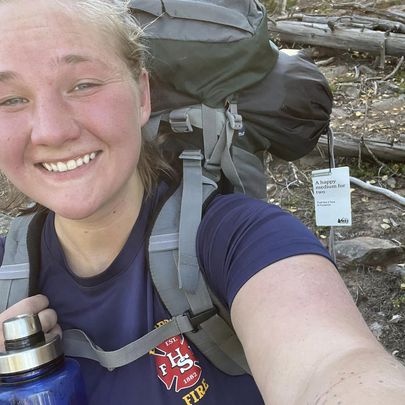 Jessica Land taking a selfie on her Outdoor Backpacking trip hike. 