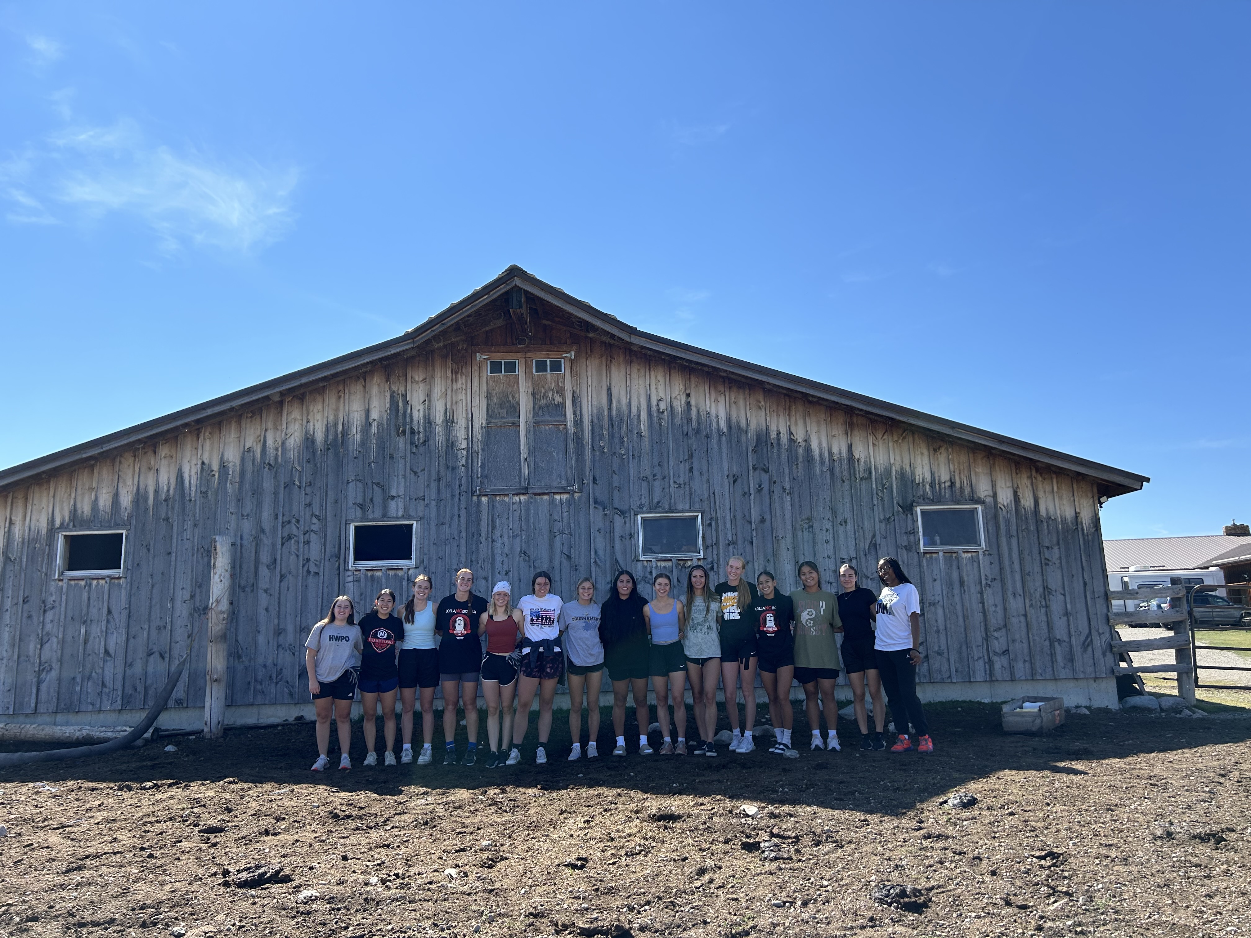 Women's basketball outside a barn. 